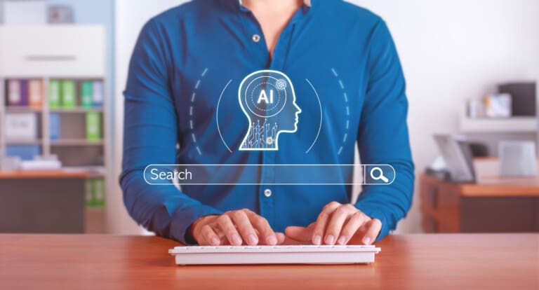 Person typing on keyboard with AI search concept overlay showing a digital head silhouette with AI circuitry and a search bar