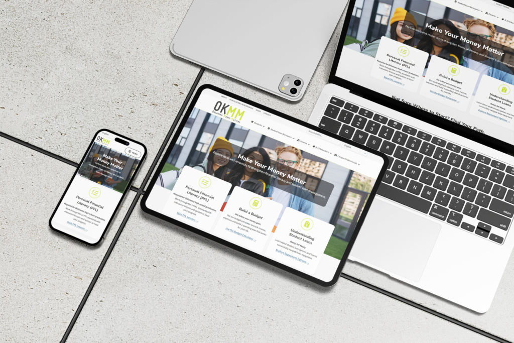 Oklahoma Money Matters responsive website design displayed on smartphone, tablet, and laptop devices.